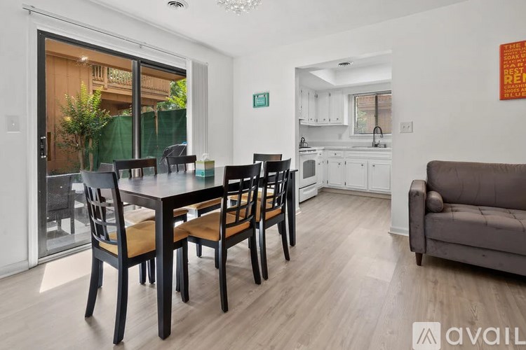 A dining room with a table and chairs is available for rent.