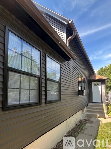 A house with a brown siding and a white door.