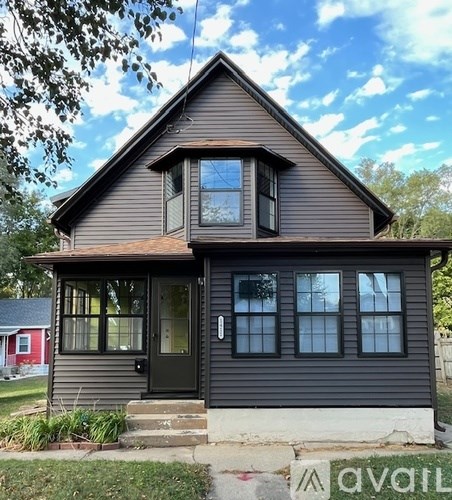 A house with a black front door and a small porch.