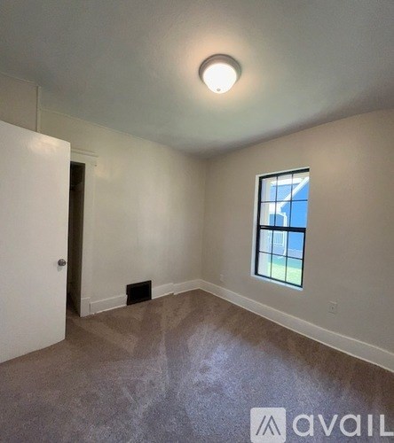 A room with a window and a door.