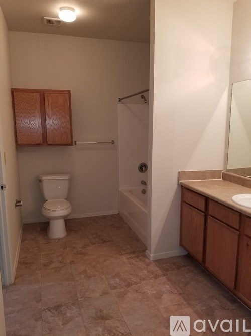 A bathroom with a toilet, sink, and shower.