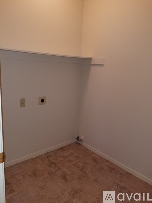 A room with a tiled floor and a white wall.