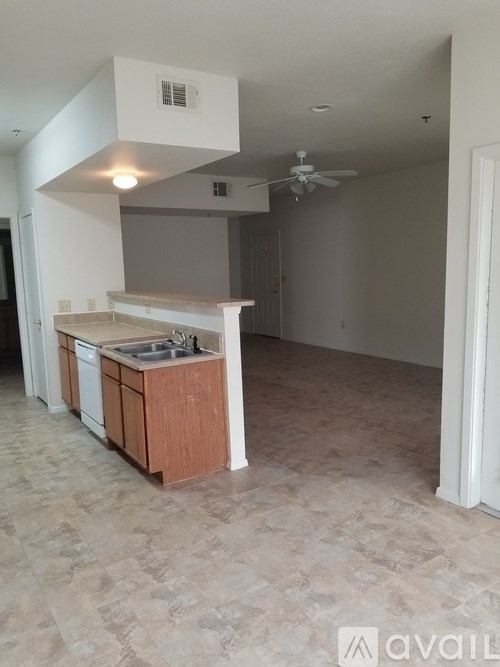 A kitchen with a countertop and a fan on the ceiling.