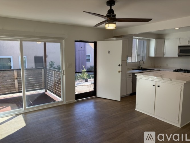 A kitchen with a marble countertop and stainless steel appliances.