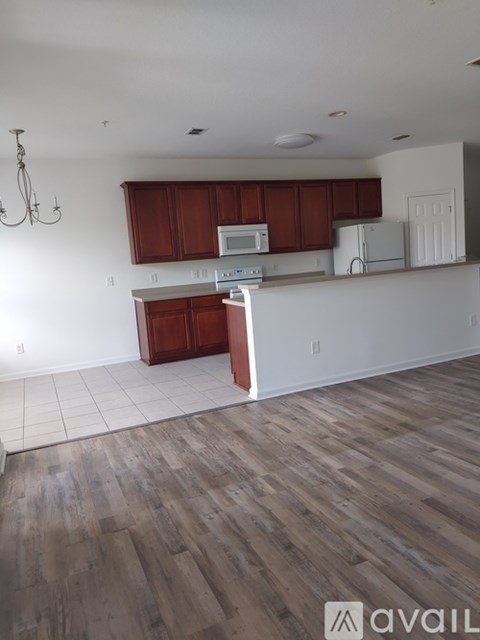 A kitchen with wooden cabinets and a white countertop.