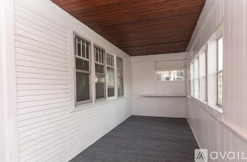 A room with white walls and a wooden ceiling.