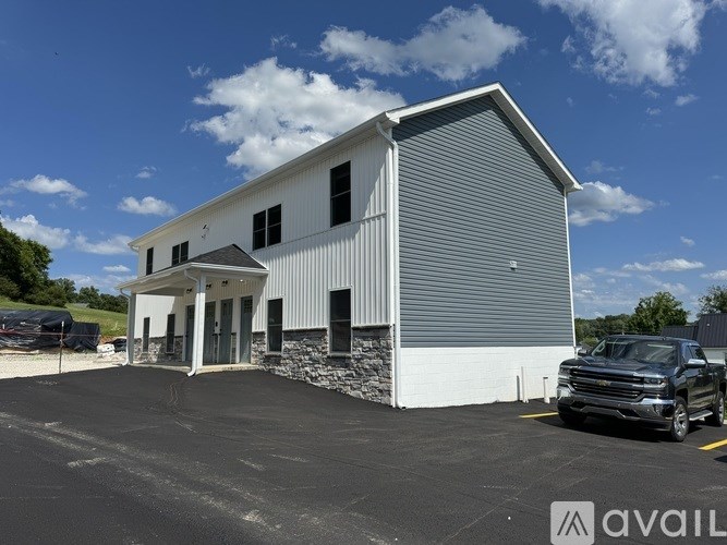A large building with a truck parked in front.