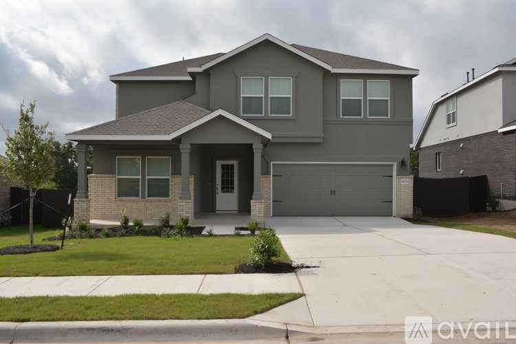 A two-story house with a garage is available for sale.