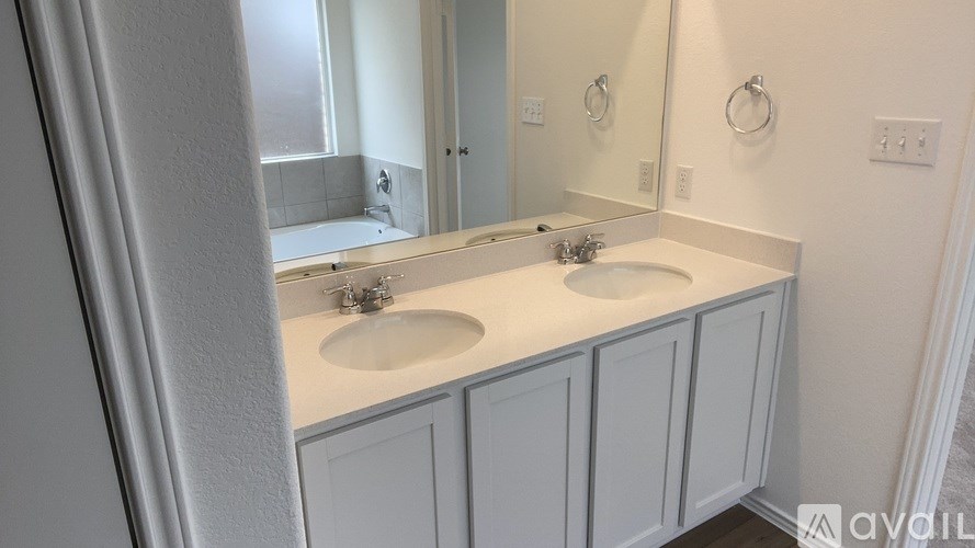 A bathroom with two sinks and a mirror.