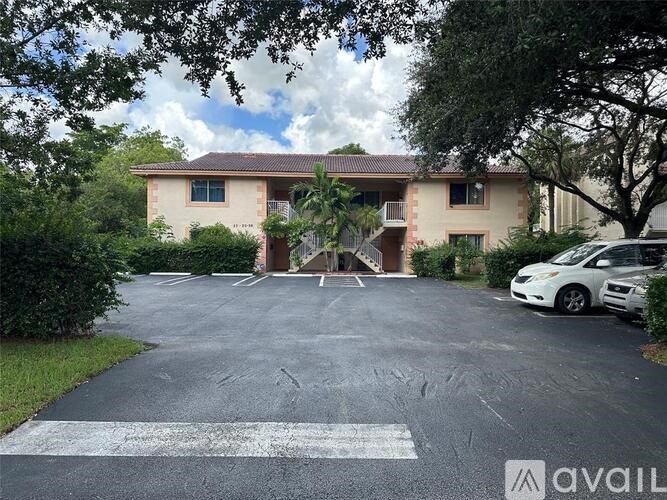 A house with a driveway and a car parked in front.