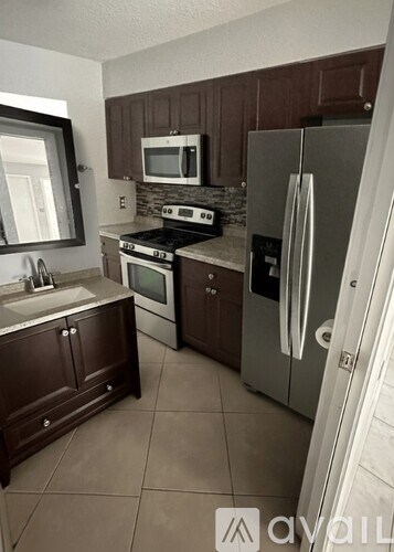 A room with a ceiling fan and two doors, one of which is open.