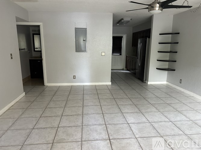A hallway with a light switch on the wall.