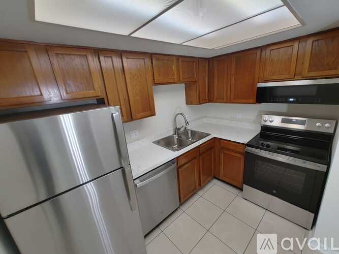 A kitchen with wooden cabinets and stainless steel appliances.