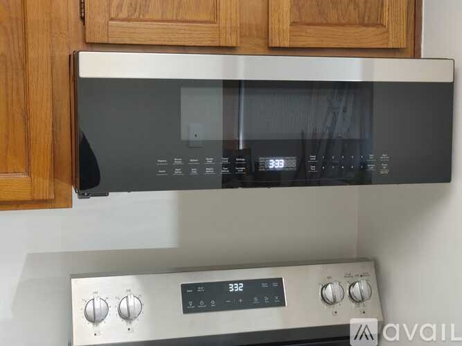 A stainless steel oven with a digital display and control panel.
