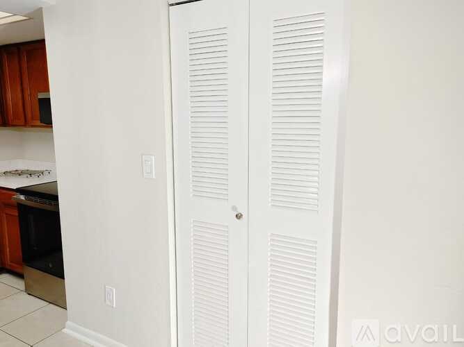 A white door with a silver handle is closed.