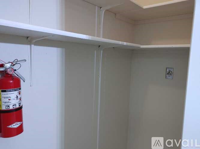 A red fire extinguisher is hanging on the wall.