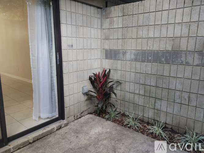 A white curtain hangs on a glass door.