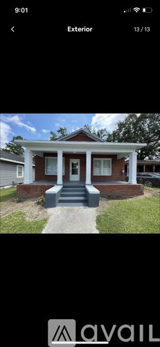 A house with a red brick exterior and white trim.
