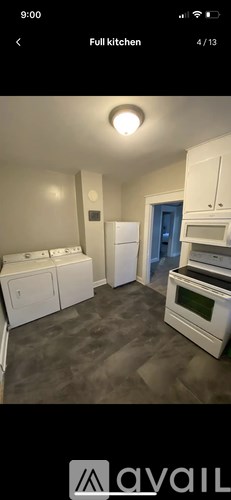 A full kitchen with white appliances and a blue door.