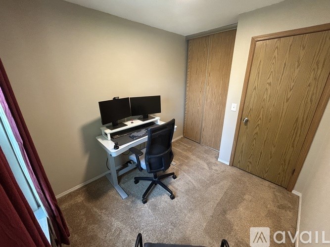 A room with a desk and a chair.