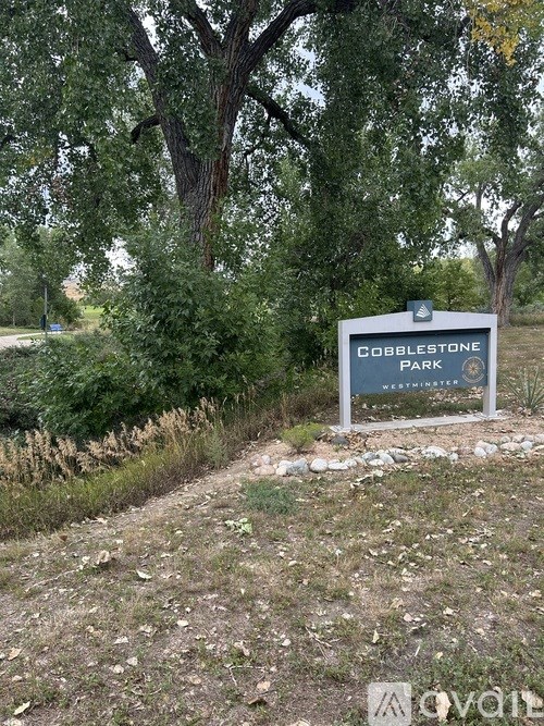 Dobblestone Park sign in front of trees.