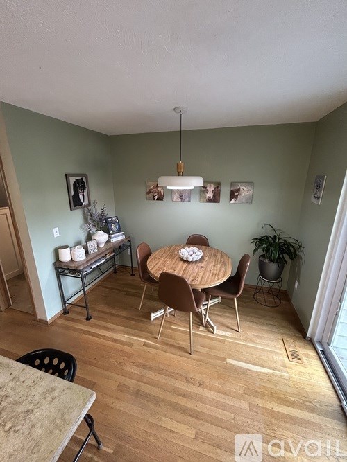 A dining area with a table and chairs.