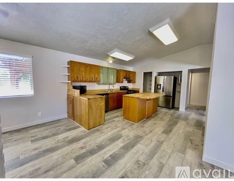 A kitchen with wooden cabinets and a central island.