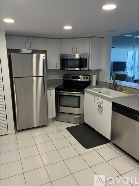 A kitchen with white cabinets and appliances.