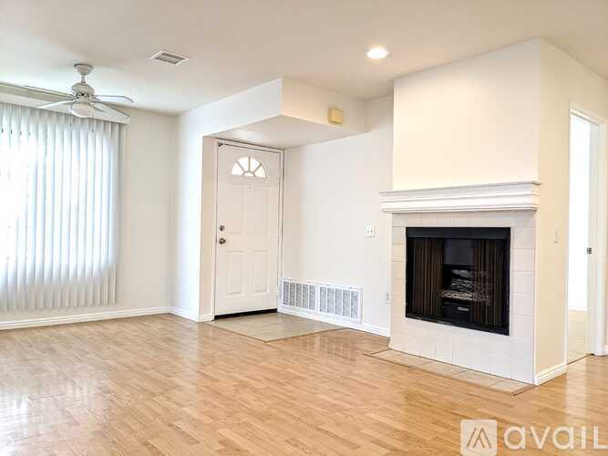 A living room with a fireplace and a door.