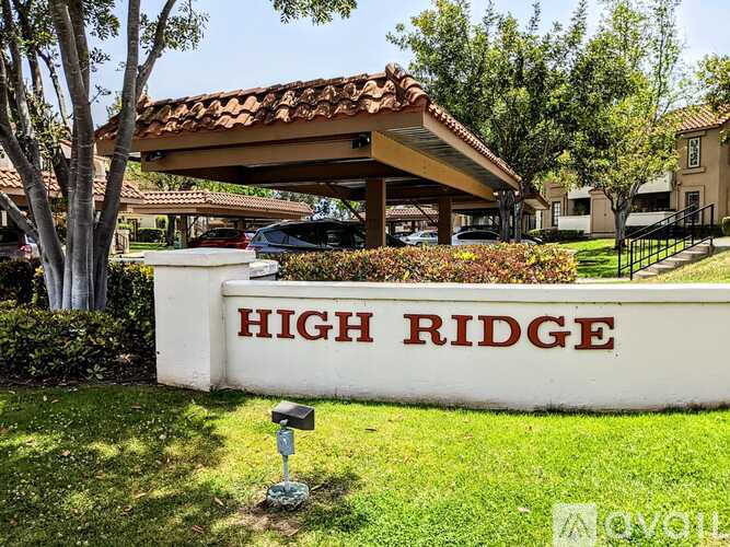 A sign that says High Ridge in front of a building.