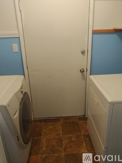 A white door with a silver handle is closed.