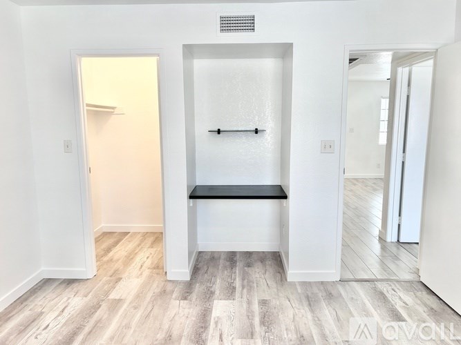 A bathroom with a bench and a shower.