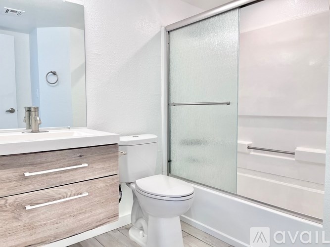 A white toilet sits next to a sink in a bathroom.