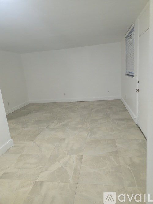 A room with a tiled floor and white walls.