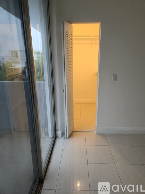 A room with a white door and a glass wall.