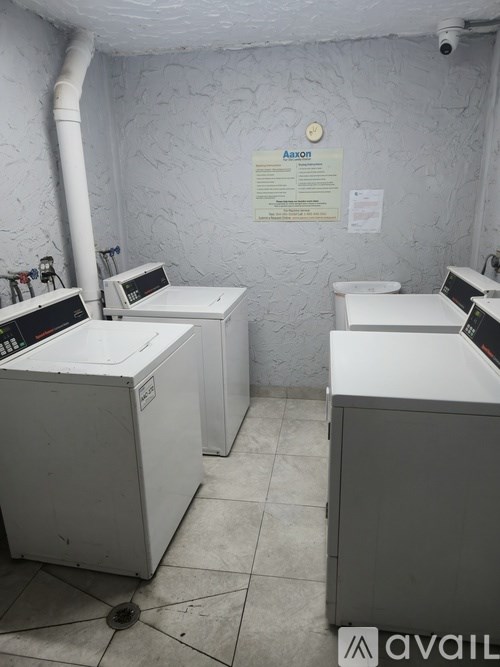 A room with two machines and a sign on the wall.