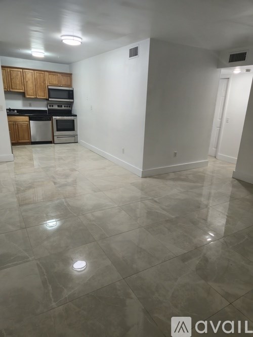 A kitchen with tile flooring and a countertop.