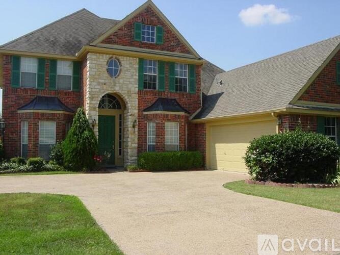 A house with a green door and a circular window above it.
