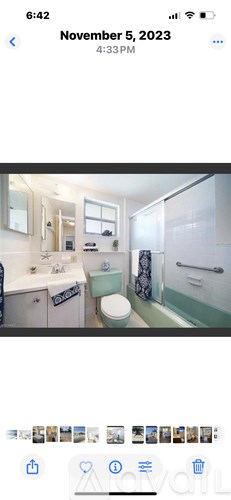 A bathroom with a toilet, sink, and shower.