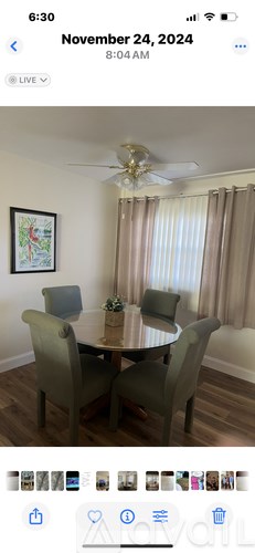 A dining room with a table and chairs.