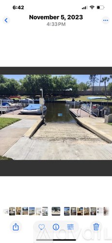 A canal with a boat and a bridge in the background.