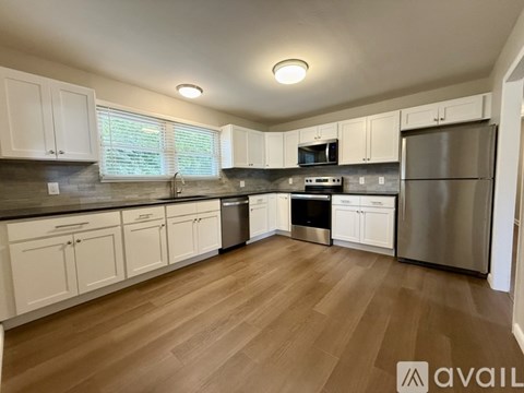 A kitchen with white cabinets and stainless steel appliances.