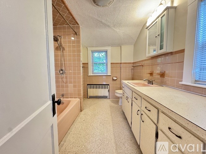 A room with wooden floors and a ceiling fan.