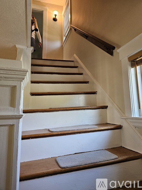 A staircase with a person walking up it.