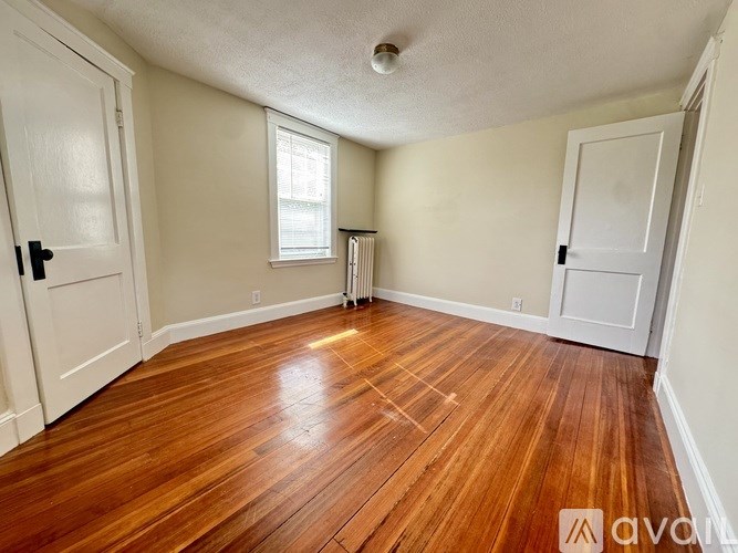 A bathroom with a tub, sink, and window.