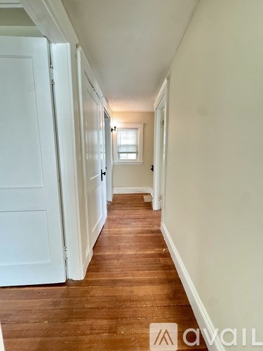 A bathroom with a tub, toilet, and sink.