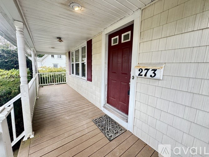 A room with a brick wall and a window, with a large piece of equipment in the corner.