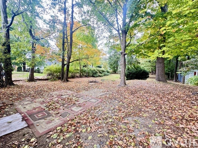 A brown door with the number 273 on the side of a white house.