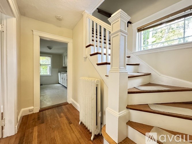 A room with wooden floors and white trimmed walls.