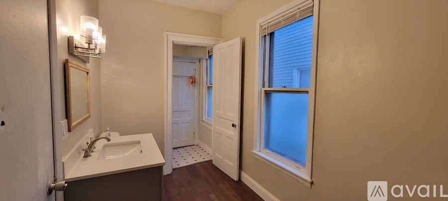 A bathroom with a sink and mirror.